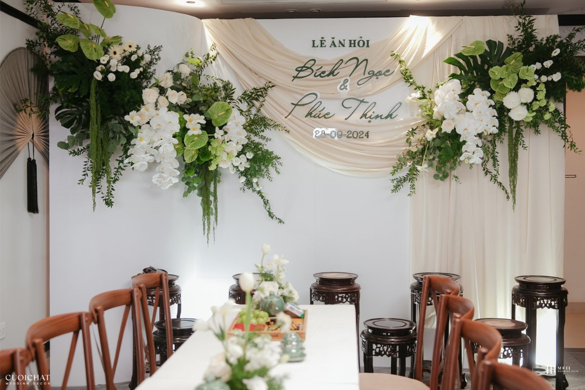 Backdrop lá xanh kết hợp hoa trắng mang đến vẻ đẹp tinh khôi, trang nhã và đầy sức sống cho không gian lễ ăn hỏi. (Ảnh: TIFF.vn)